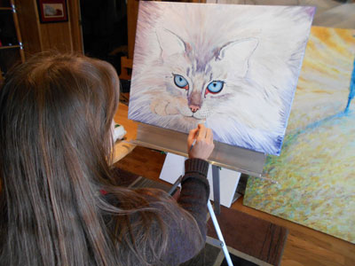 Anastasia Nelson painting a commissioned work